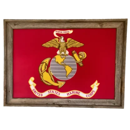 A framed United States Marine Corps flag featuring the Eagle, Globe, and Anchor emblem on a red background. The banner above reads "Semper Fidelis," and a rustic wooden frame surrounds the flag.