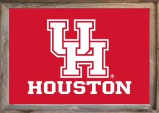 Framed University of Houston flag featuring a bold red background with the white interlocking "UH" logo and "HOUSTON" in block letters beneath it, all encased in a rustic wooden frame.